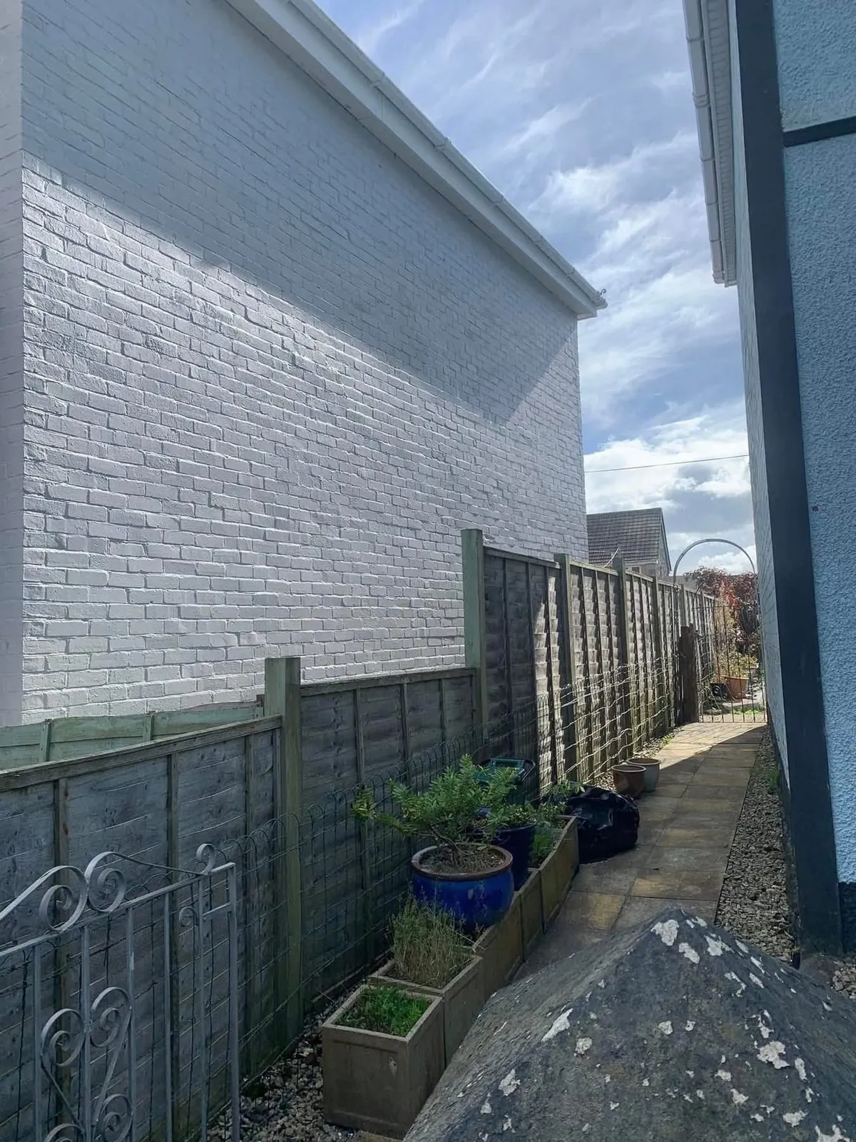 Freshly painted brick wall after preparation and masonry paint in Truro