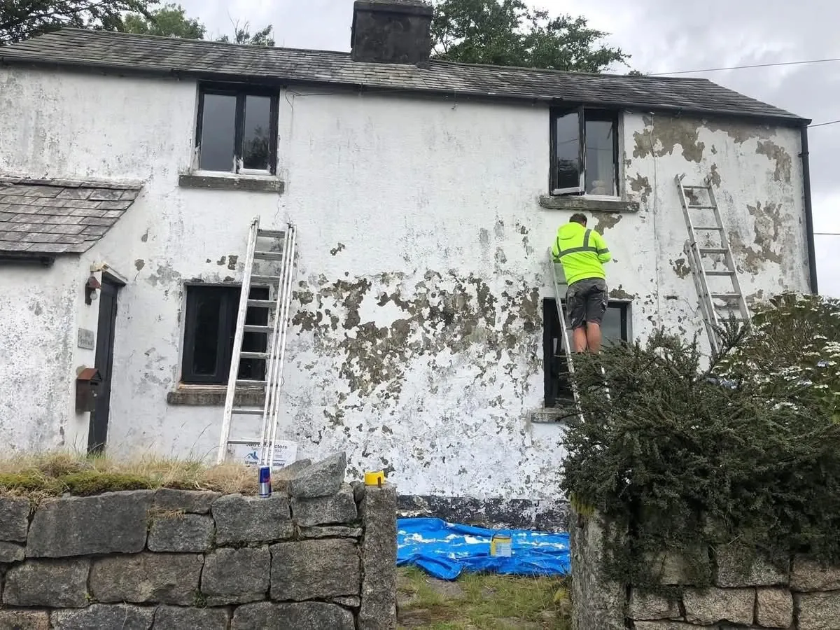 Cottage with blown, flaking render before repair in Truro